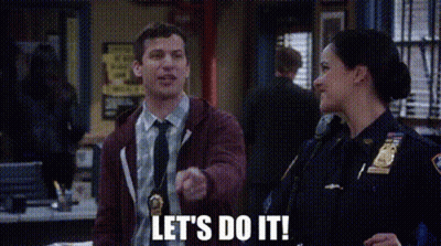 A Man And A Woman Are Standing Next To Each Other In A Police Station . The Man Is Pointing At The Woman . GIF