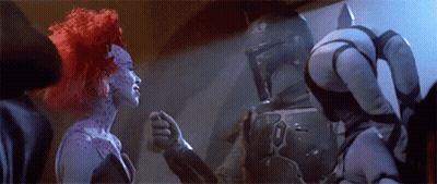 A Man And A Woman Are Standing Next To Each Other In A Room . GIF