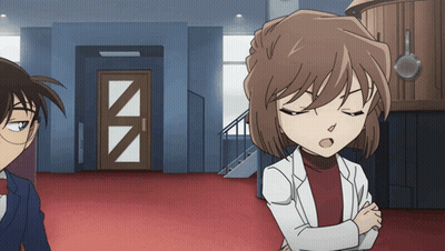 A Man And A Woman Are Standing Next To Each Other In A Room GIF