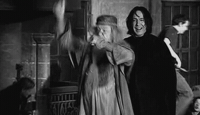 A Man And A Woman Are Standing Next To Each Other In A Room In A Black And White Photo . GIF