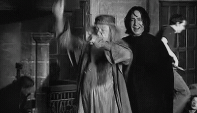 A Man And A Woman Are Standing Next To Each Other In A Room In A Black And White Photo . GIF