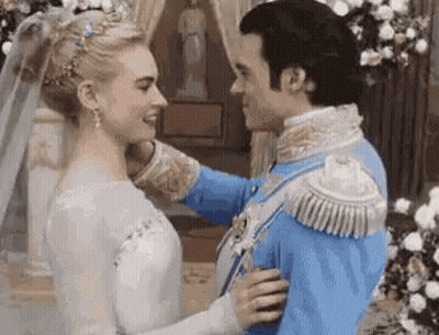 A Man And A Woman Are Standing Next To Each Other In A Room . GIF