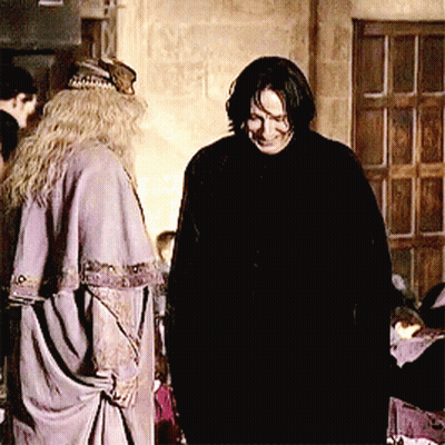A Man And A Woman Are Standing Next To Each Other In A Room GIF