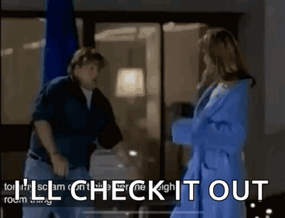 A Man And A Woman Are Standing Next To Each Other In A Room With The Words I 'Ll Check It Out . GIF