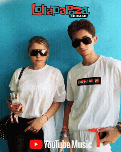 A Man And A Woman Are Standing Next To Each Other In Front Of A Blue Wall That Says Lolaplaza Chicago GIF