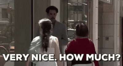 A Man And A Woman Are Standing Next To Each Other In Front Of A Building . The Woman Is Asking The Man How Much . GIF