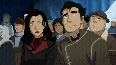 a man and a woman are standing next to each other in front of a crowd