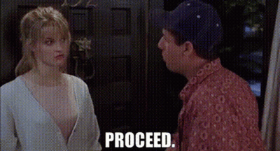 A Man And A Woman Are Standing Next To Each Other In Front Of A Door And The Words Proceed Are Visible . GIF