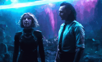 A Man And A Woman Are Standing Next To Each Other In Front Of A Purple Background . GIF