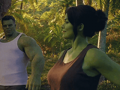 A Man And A Woman Are Standing Next To Each Other In The Jungle GIF