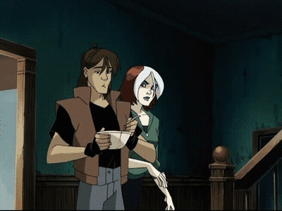A Man And A Woman Are Standing Next To Each Other GIF