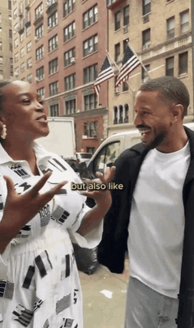 A Man And A Woman Are Standing Next To Each Other On A Street And The Woman Says But Also Like GIF