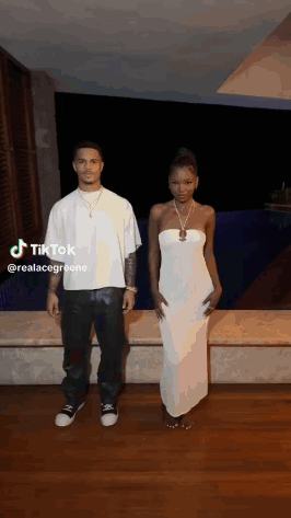 a man and a woman are standing next to each other .