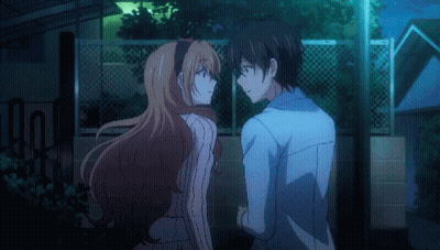 A Man And A Woman Are Standing Next To Each Other GIF