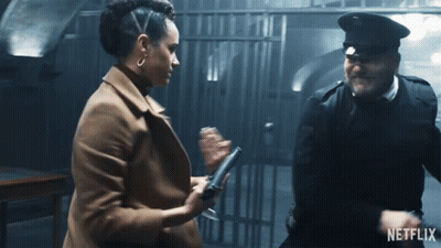 A Man And A Woman Are Standing Next To Each Other With A Netflix Logo On The Bottom GIF