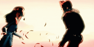 A Man And A Woman Are Standing Next To Each Other With Feathers Flying Around Them GIF