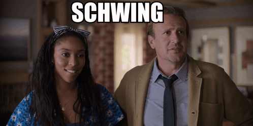 A Man And A Woman Are Standing Next To Each Other With Schwing Written On The Screen GIF