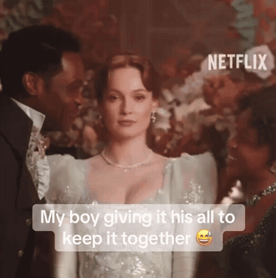 A Man And A Woman Are Standing Next To Each Other With The Caption " My Boy Giving It His All To Keep It Together GIF