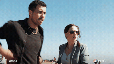 A Man And A Woman Are Standing Next To Each Other With The Nbc Logo Visible GIF