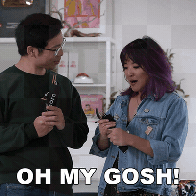 A Man And A Woman Are Standing Next To Each Other With The Woman Saying Oh My Gosh GIF