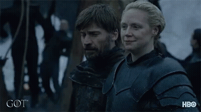 A Man And A Woman Are Standing Next To Each Other With The Word Got On The Bottom Right GIF