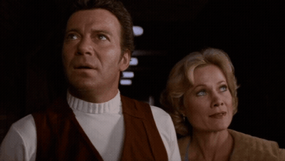 A Man And A Woman Are Standing Next To Each Other With The Words Can I Cook Or Can 'T I GIF