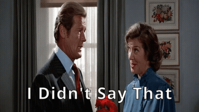 A Man And A Woman Are Standing Next To Each Other With The Words I Did N't Say That Written Above Them GIF
