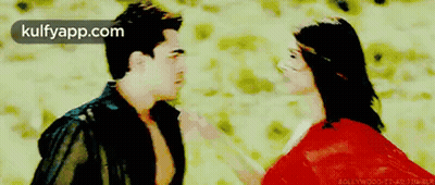 A Man And A Woman Are Standing Next To Each Other With The Words Kulfyapp.com On The Bottom Right GIF