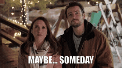 A Man And A Woman Are Standing Next To Each Other With The Words Maybe Someday Written Below Them GIF