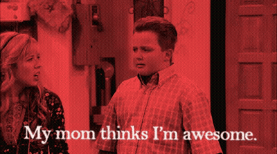 A Man And A Woman Are Standing Next To Each Other With The Words My Mom Thinks I 'M Awesome GIF