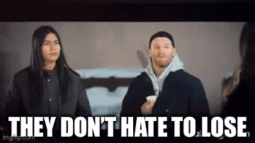 A Man And A Woman Are Standing Next To Each Other With The Words `` They Don 'T Hate To Lose '' . GIF