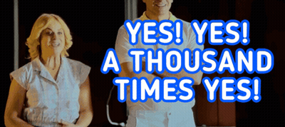 A Man And A Woman Are Standing Next To Each Other With The Words Yes Yes A Thousand Times Yes Behind Them GIF