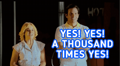A Man And A Woman Are Standing Next To Each Other With The Words Yes Yes A Thousand Times Yes Behind Them GIF