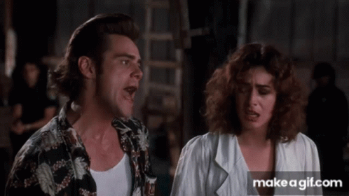 A Man And A Woman Are Standing Next To Each Other With Their Mouths Open GIF