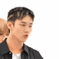 A Man And A Woman Are Standing Next To Each Other . GIF