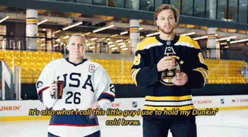 A Man And A Woman Are Standing On A Ice Rink And The Man Is Wearing A Usa Jersey GIF