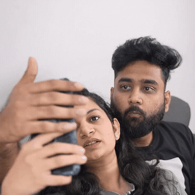 A Man And A Woman Are Taking A Selfie With Their Cell Phone GIF