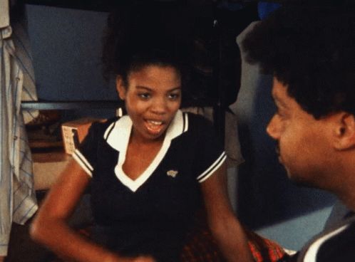 A Man And A Woman Are Talking And The Woman Is Wearing A Shirt With A Lacoste Logo On It GIF