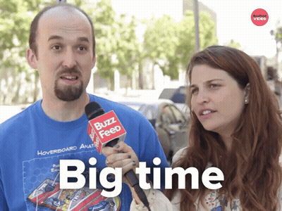 A Man And A Woman Are Talking To A Buzz Feed Reporter GIF
