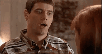 A Man And A Woman Are Talking To Each Other And The Man Is Making A Surprised Face . GIF