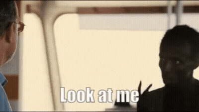 A Man And A Woman Are Talking To Each Other And The Man Is Saying Look At Me . GIF