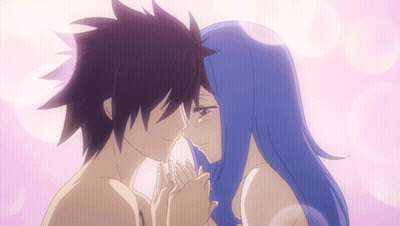 A Man And A Woman Are Touching Each Other 'S Faces GIF