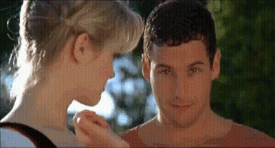 A Man And A Woman Are Touching Each Other 'S Faces In A Movie . GIF