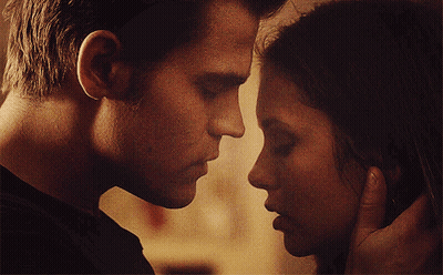 A Man And A Woman Are Touching Their Faces GIF