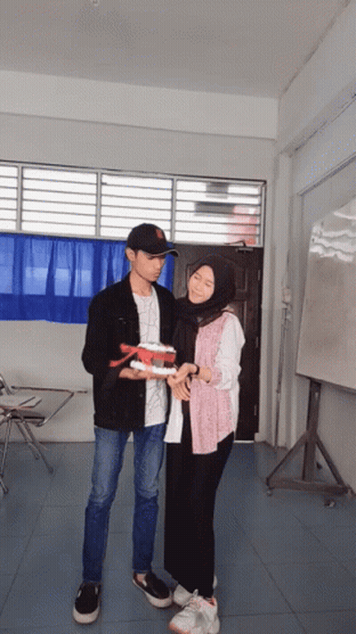 A Man And A Woman Are Upside Down Holding Hands GIF