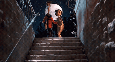 A Man And A Woman Are Walking Down A Set Of Stairs GIF