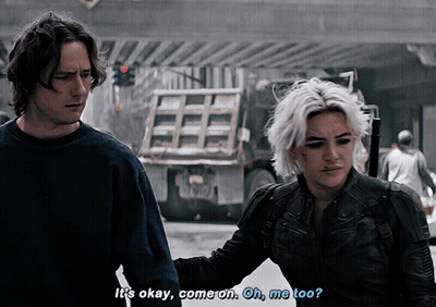 A Man And A Woman Are Walking Down A Street And The Man Says It 'S Okay Come On Oh Me Too GIF
