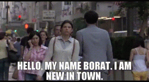 A Man And A Woman Are Walking Down A Street And The Woman Says Hello My Name Borat I Am New In Town GIF
