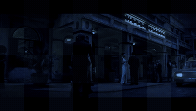 A Man And A Woman Are Walking In The Dark GIF