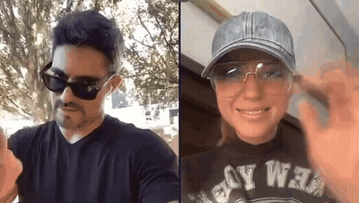 A Man And A Woman Are Wearing Sunglasses And A Hat . GIF